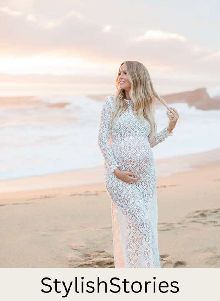 pretty pregnant woman standing on a beach at sunrise in a long white lace grown