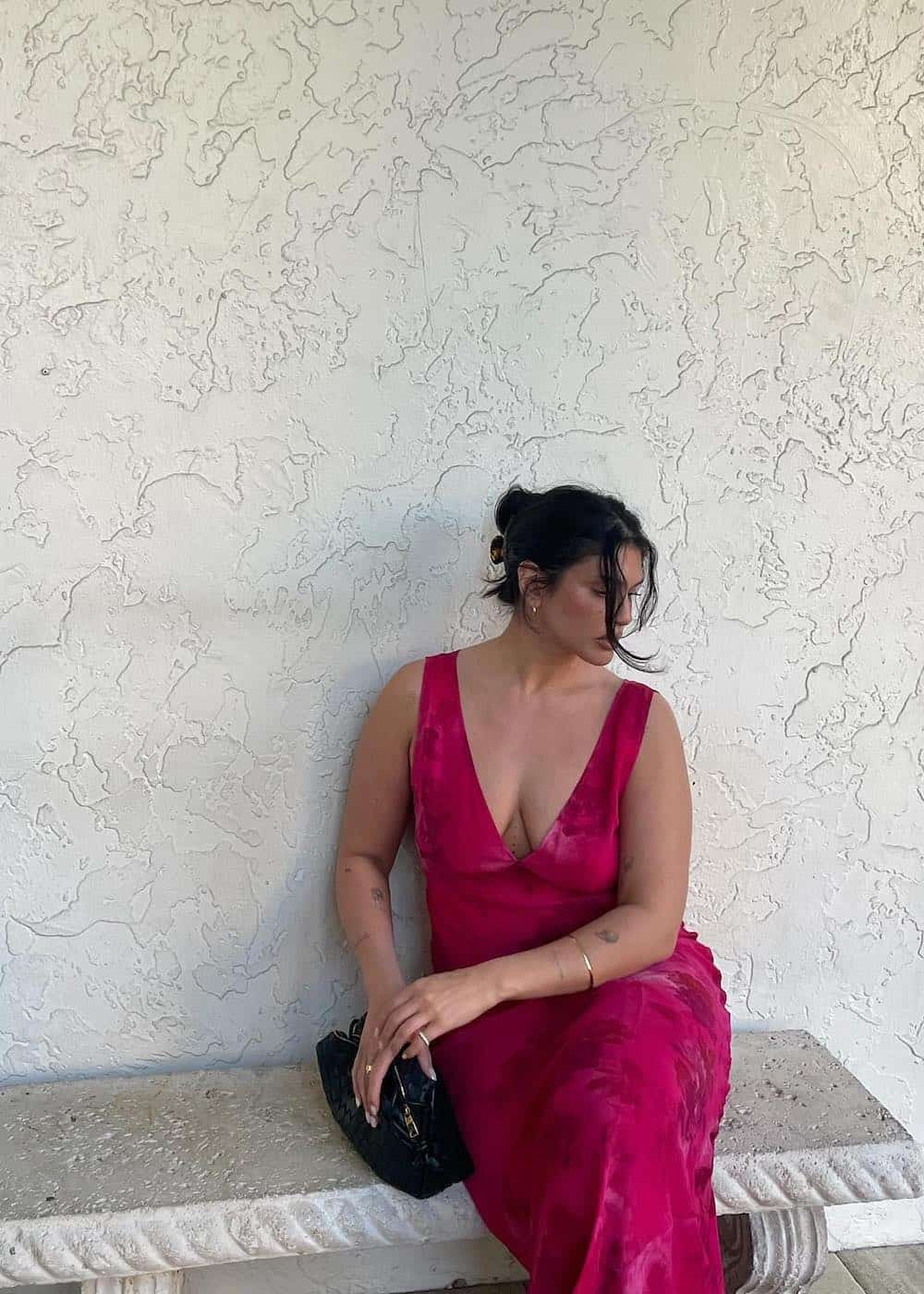a woman wearing a v-neck red floral dress