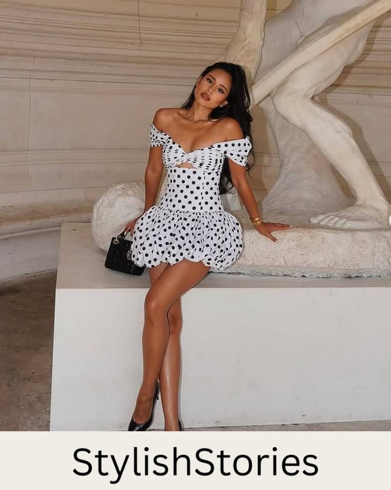 Woman wearing a black and white polka dot bubble hem dress.