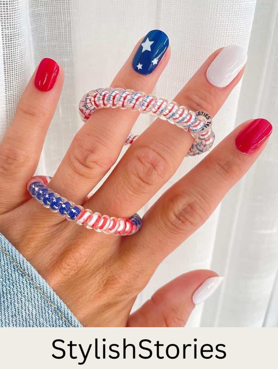short squoval nails featuring red and white nails polish and a blue accent nail with white stars