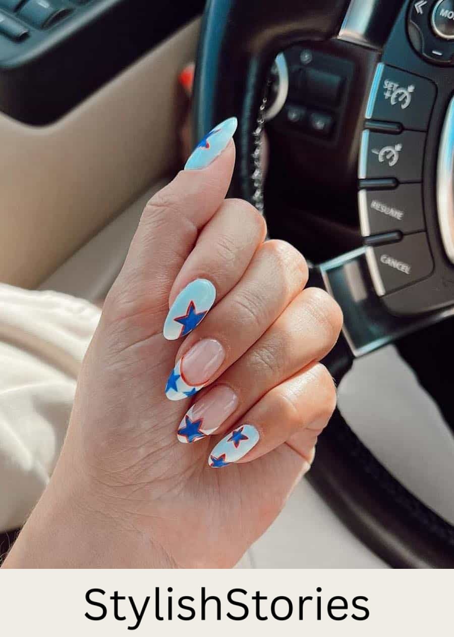 long almond white almond nails with blue and red stars and two French tip accent nails with star details