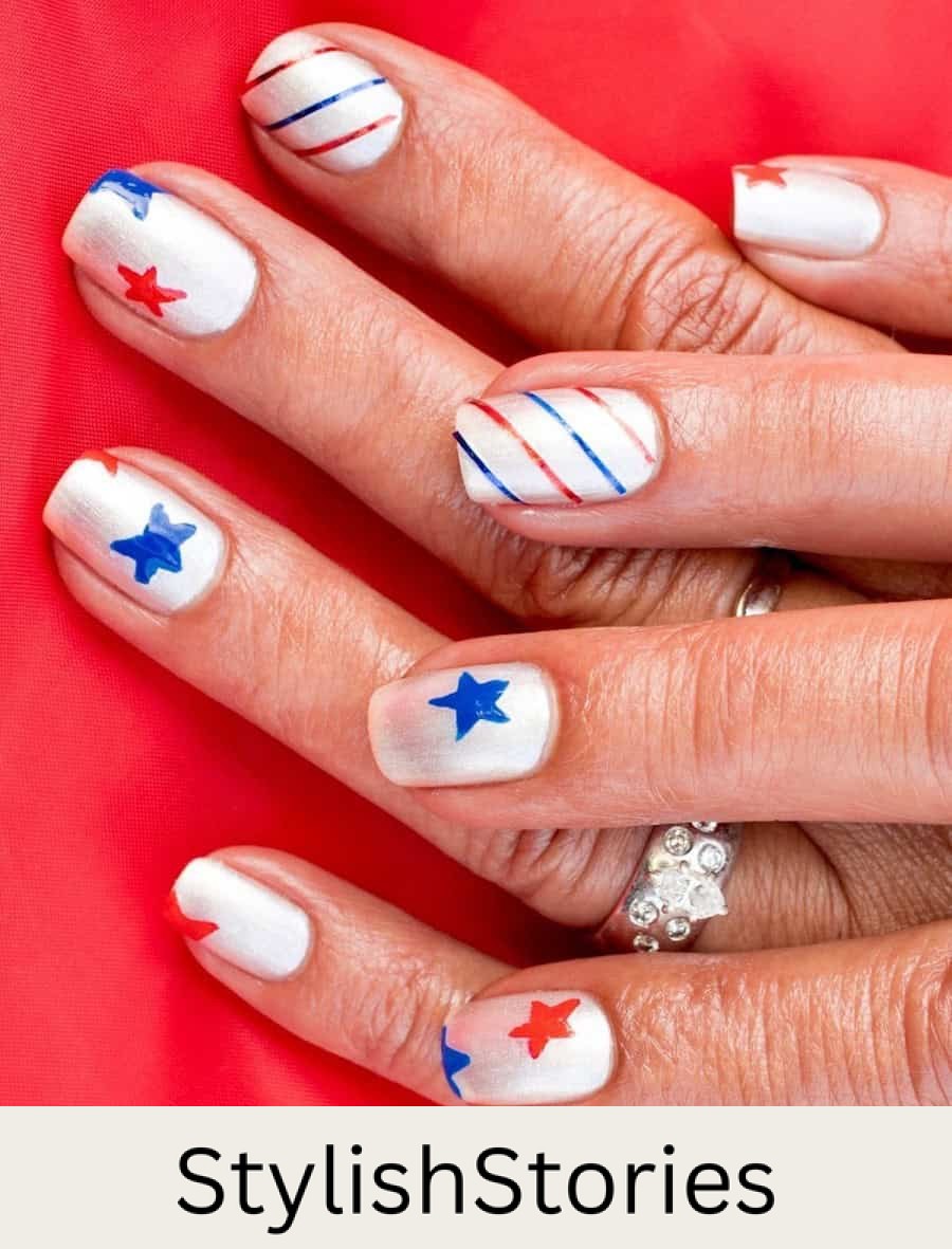 short square nails with metallic white nail polish and red and blue stars and stripes