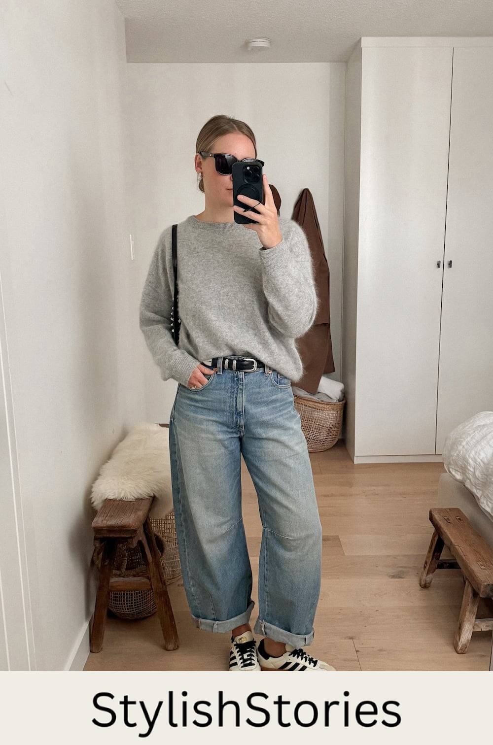 Christal wearing barrel jeans with a grey sweater and sambas.