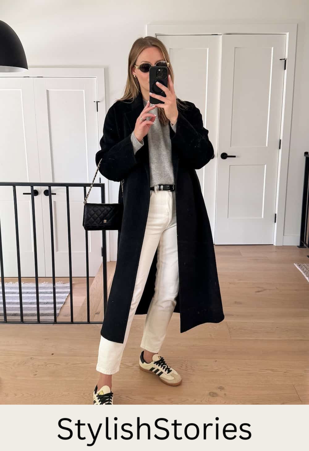 Christal wearing white jeans with a grey sweater and a long black cardigan with sambas.