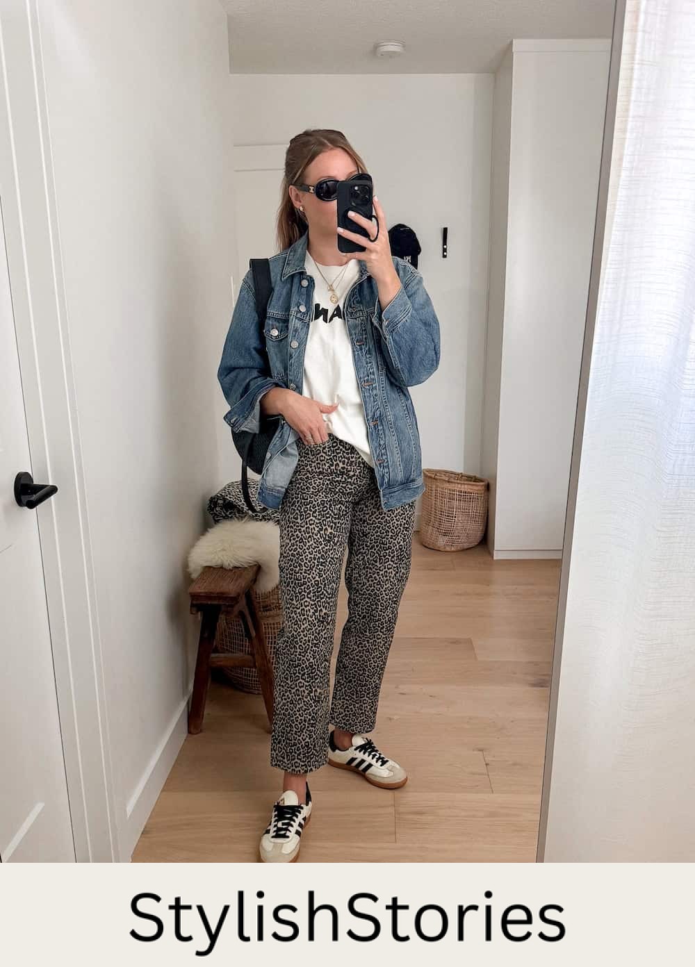 Christal wearing leopard print jeans with a white tee and denim jacket with sambas.