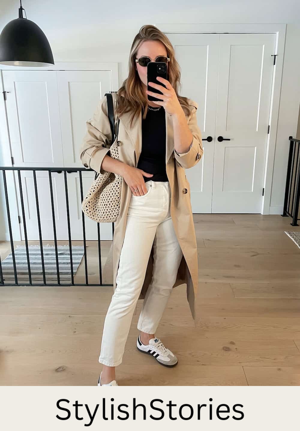 Christal wearing white jeans with a black tee, a trench coat and sambas.