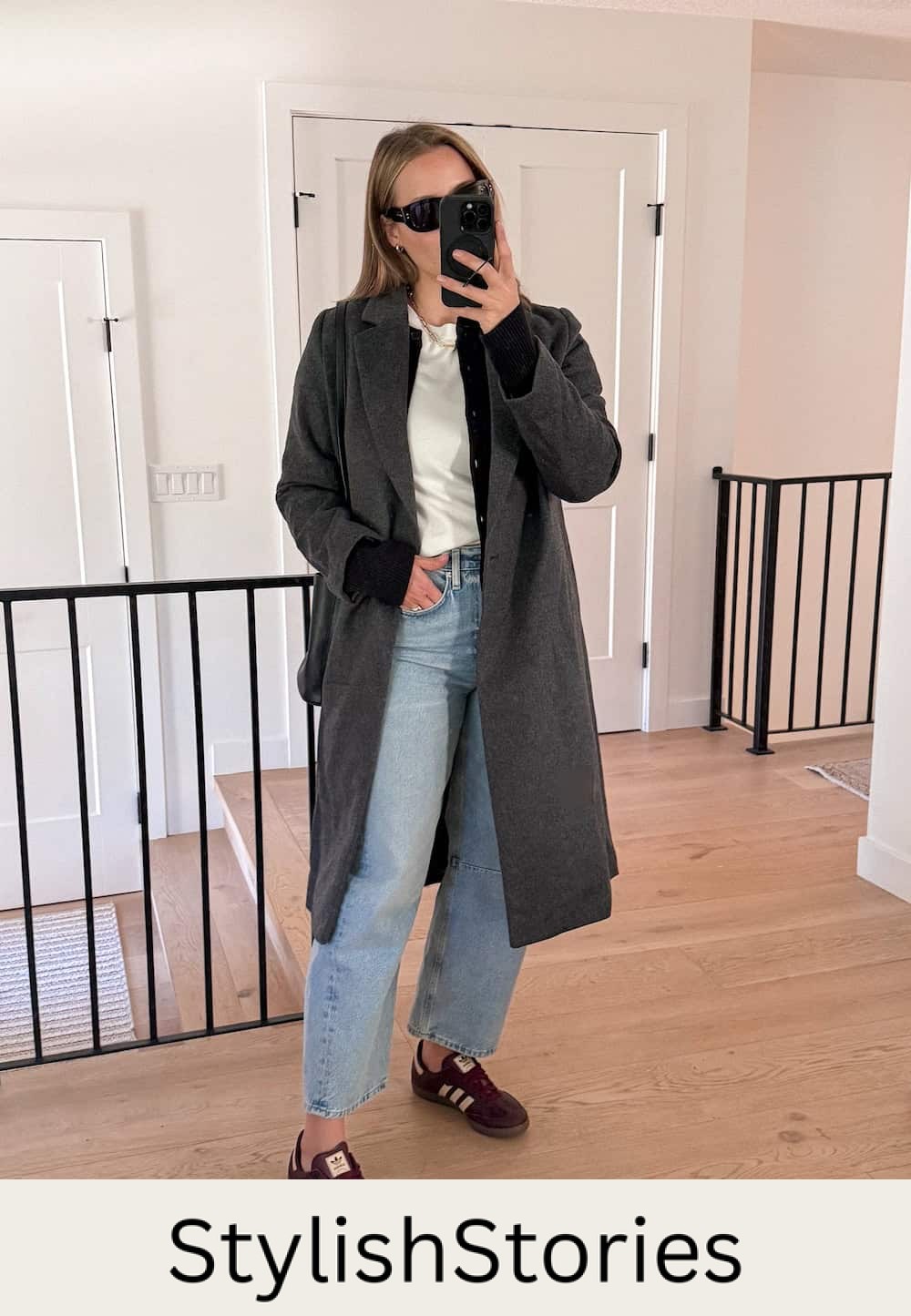 Christal wearing jeans with a white tee, a black cardigan and a grey coat with sambas.