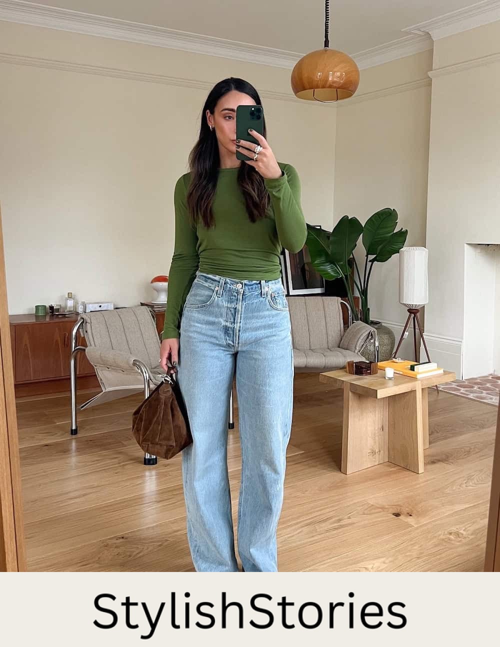 Woman wearing baggy jeans, a tight, green knit top and heeled sandals.