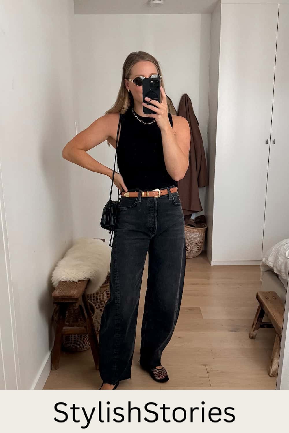 Christal wearing black baggy jeans, mesh ballet flats and a black tank top.