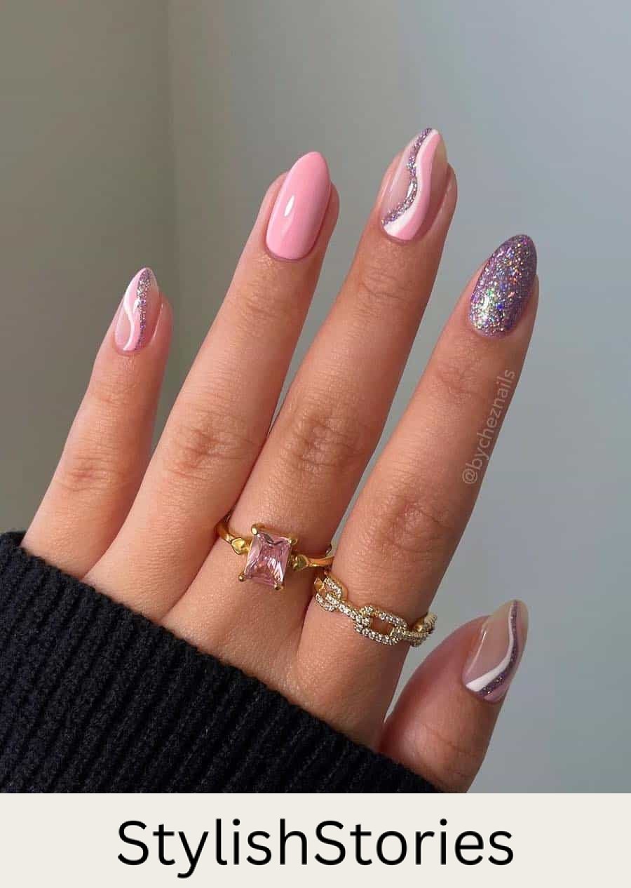 Short almond nails painted with glossy pink and glittering silver polishes with wave accent nails