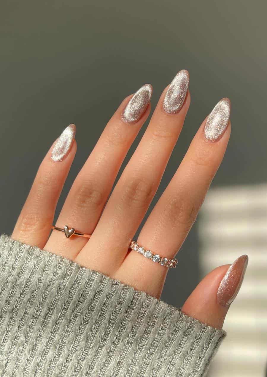 Medium beige almond nails with a shimmering velvet finish