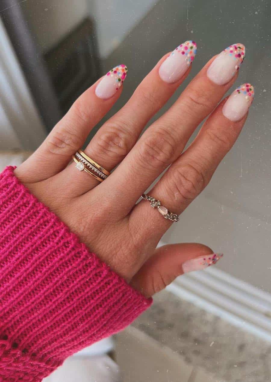 Medium milky pink almond nails with colorful confetti tips