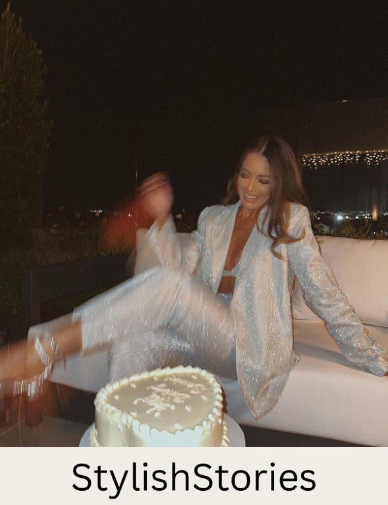 woman wearing a silver glitter pant suit with silver heels at her birthday