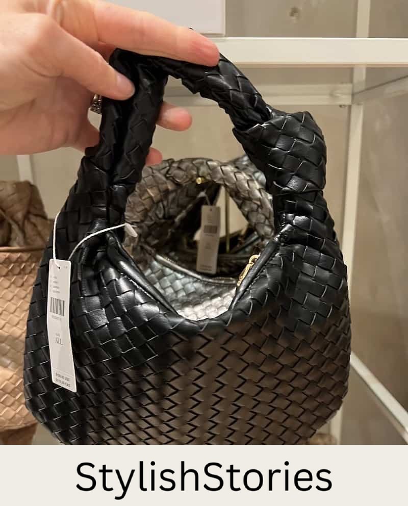 Christal holding a woven mini hobo satchel bag in black that's a dupe of the Bottega Veneta teen Jodie bag