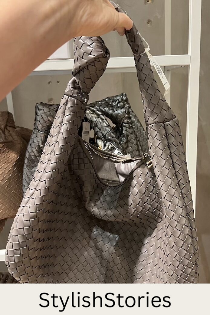 Christal holding a woven hobo satchel bag in taupe that's a dupe of the Bottega Veneta Maxi Jodie bag