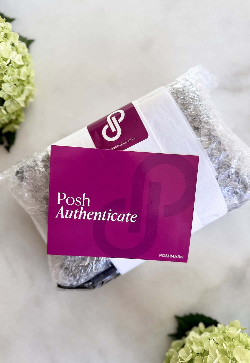 image of a bag in bubblewrap with a Posh Authenticate card on top