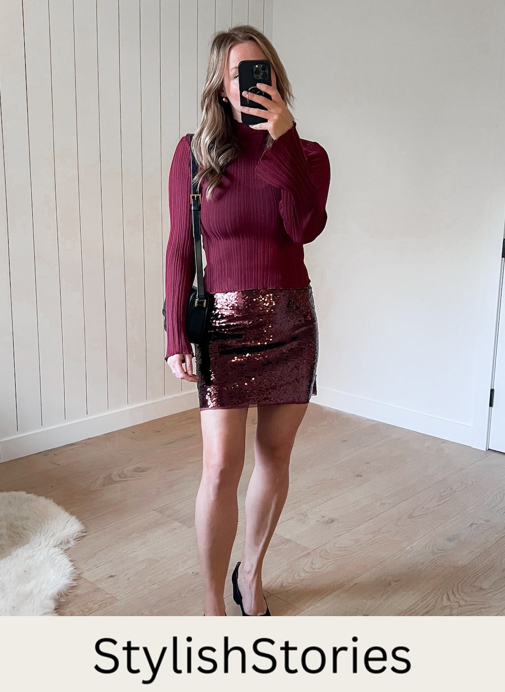 A woman wearing a sparkly burgundy mini skirt with a red knit crewneck sweater and black heels