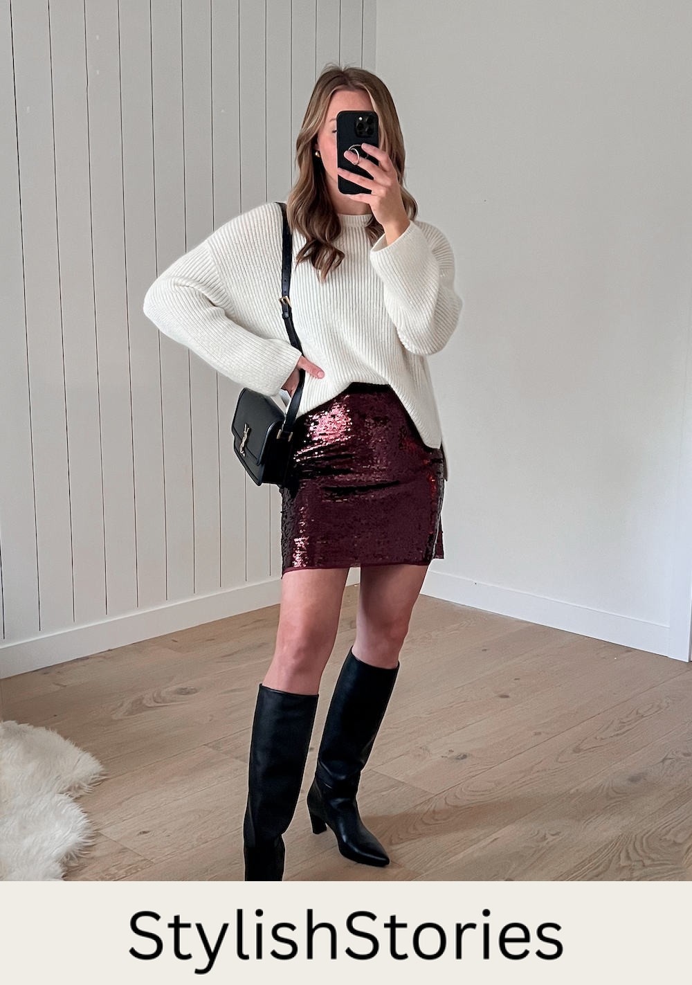 A woman wearing a sparkly burgundy mini skirt with a white knit crewneck sweater, a black shoulder bag, and knee-high black leather boots