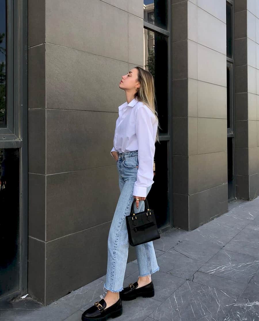 image of a woman wearing a white long-sleeve button up shirt with straight leg jeans and chunky black flats