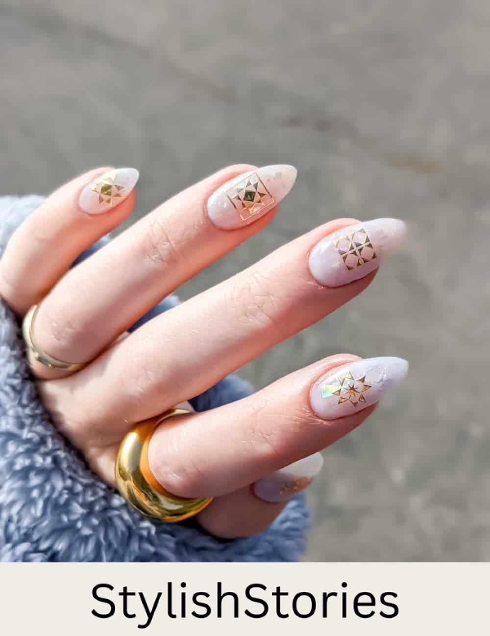 holographic white almond nails with gold accents