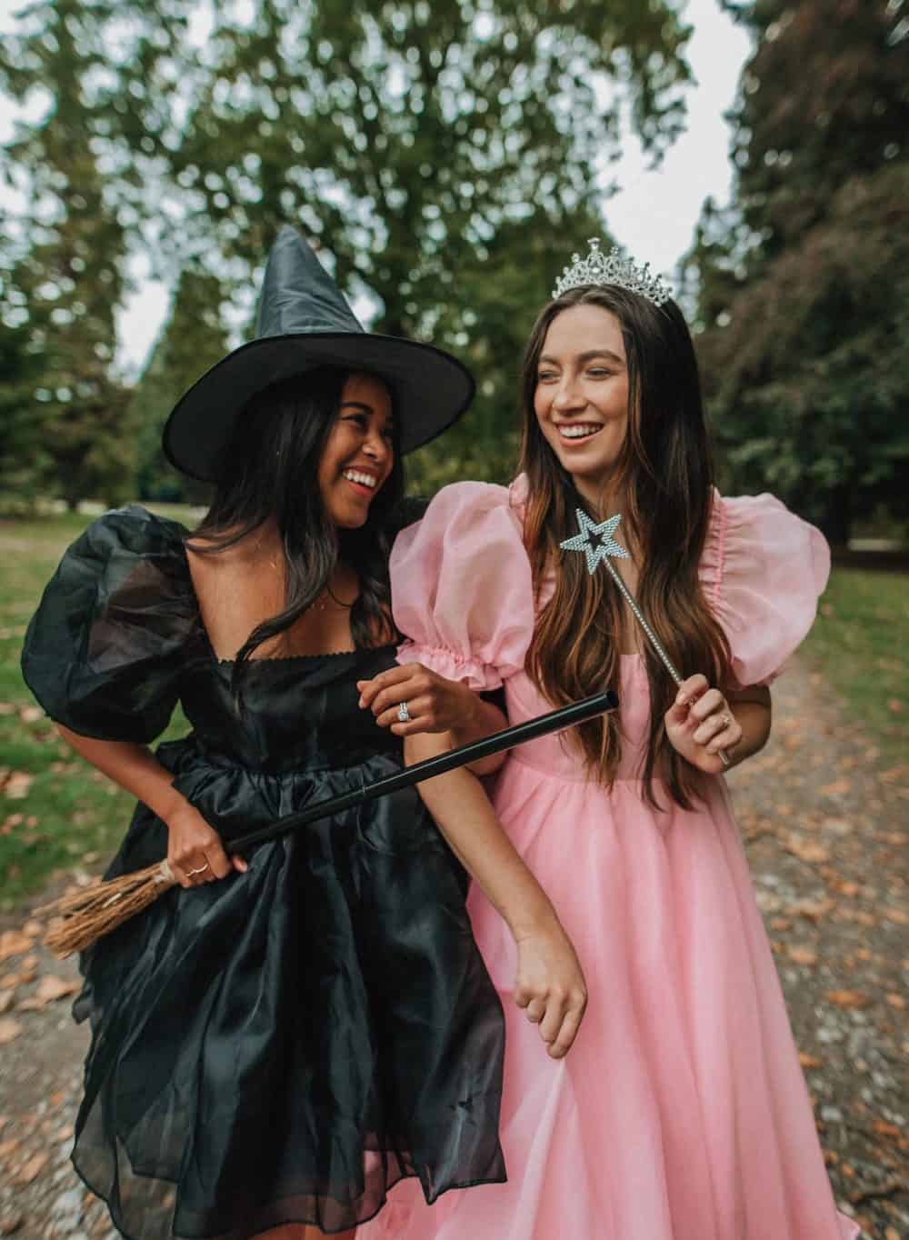 Two women dressed up as Glinda and Elphaba from Wicked on Halloween.