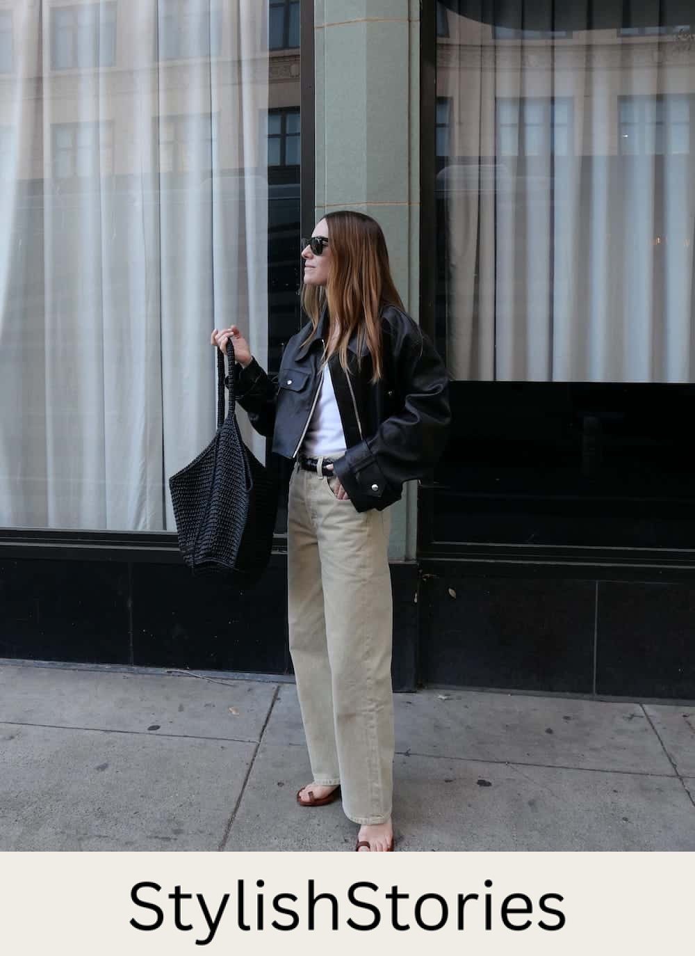 Woman wearing cargo pants with a white t-shirt and a black leather jacket.