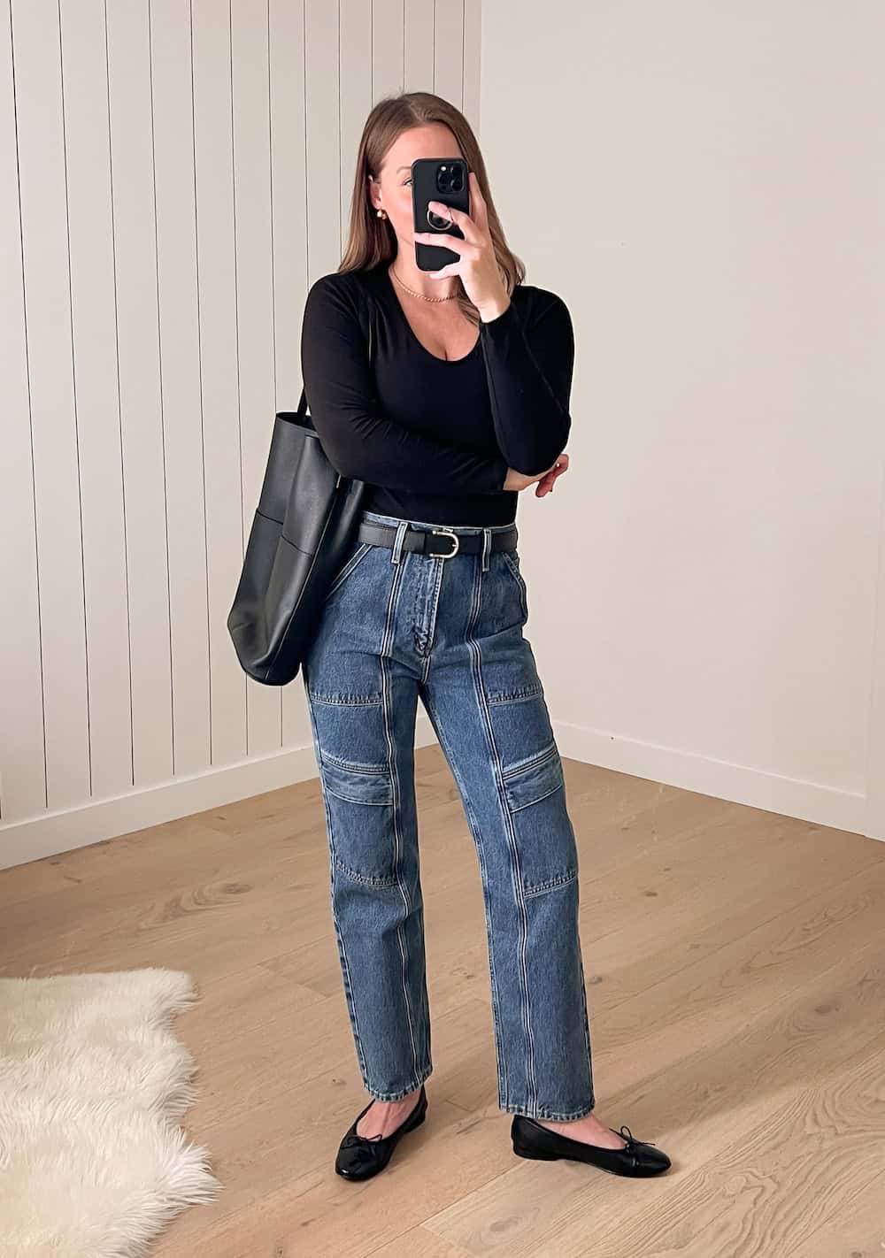 Christal wearing cargo jeans with a long sleeve knit top and ballet flats.