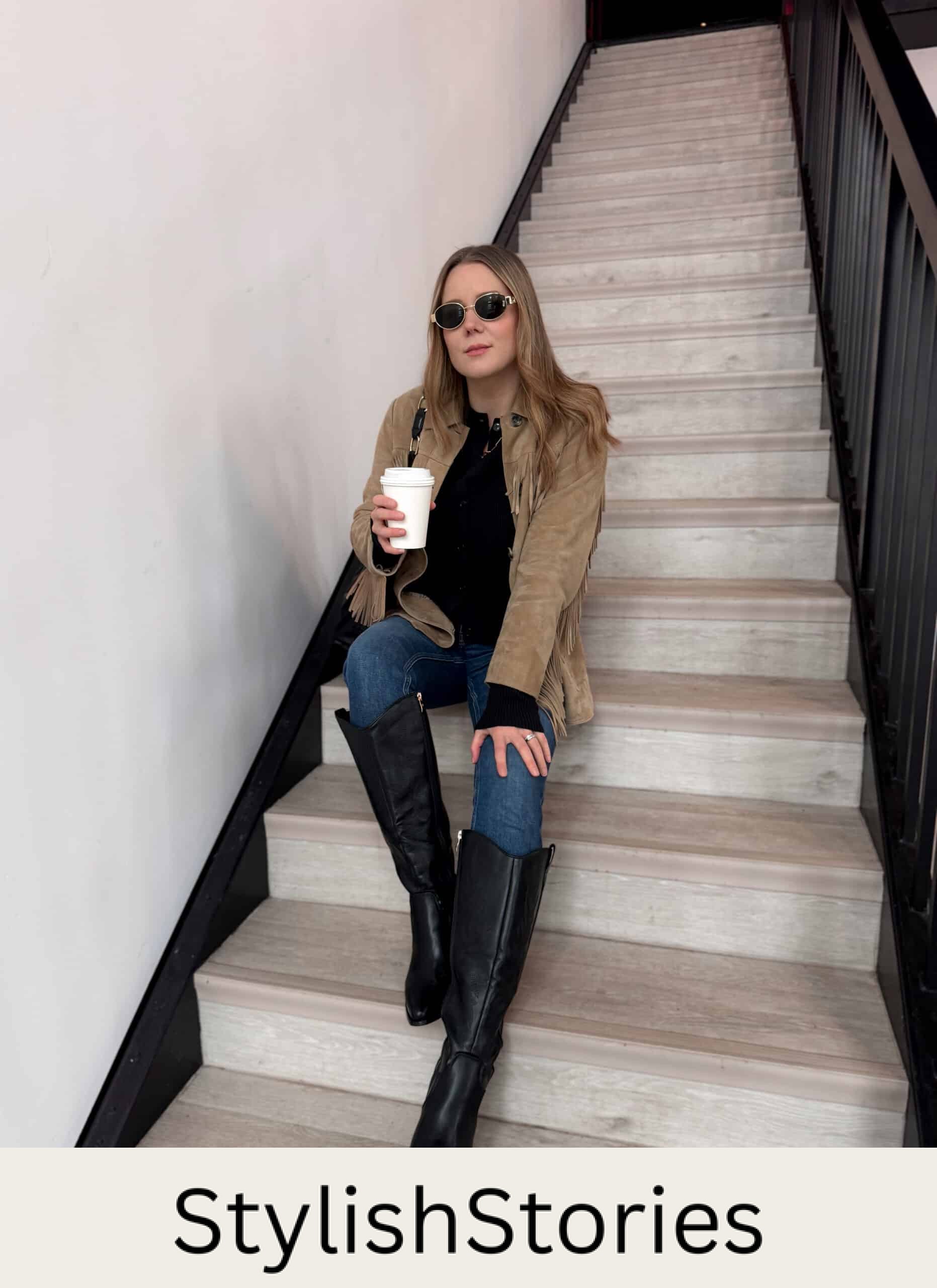 Christal wearing skinny jeans, a black top, a brown suede jacket and tall black boots.