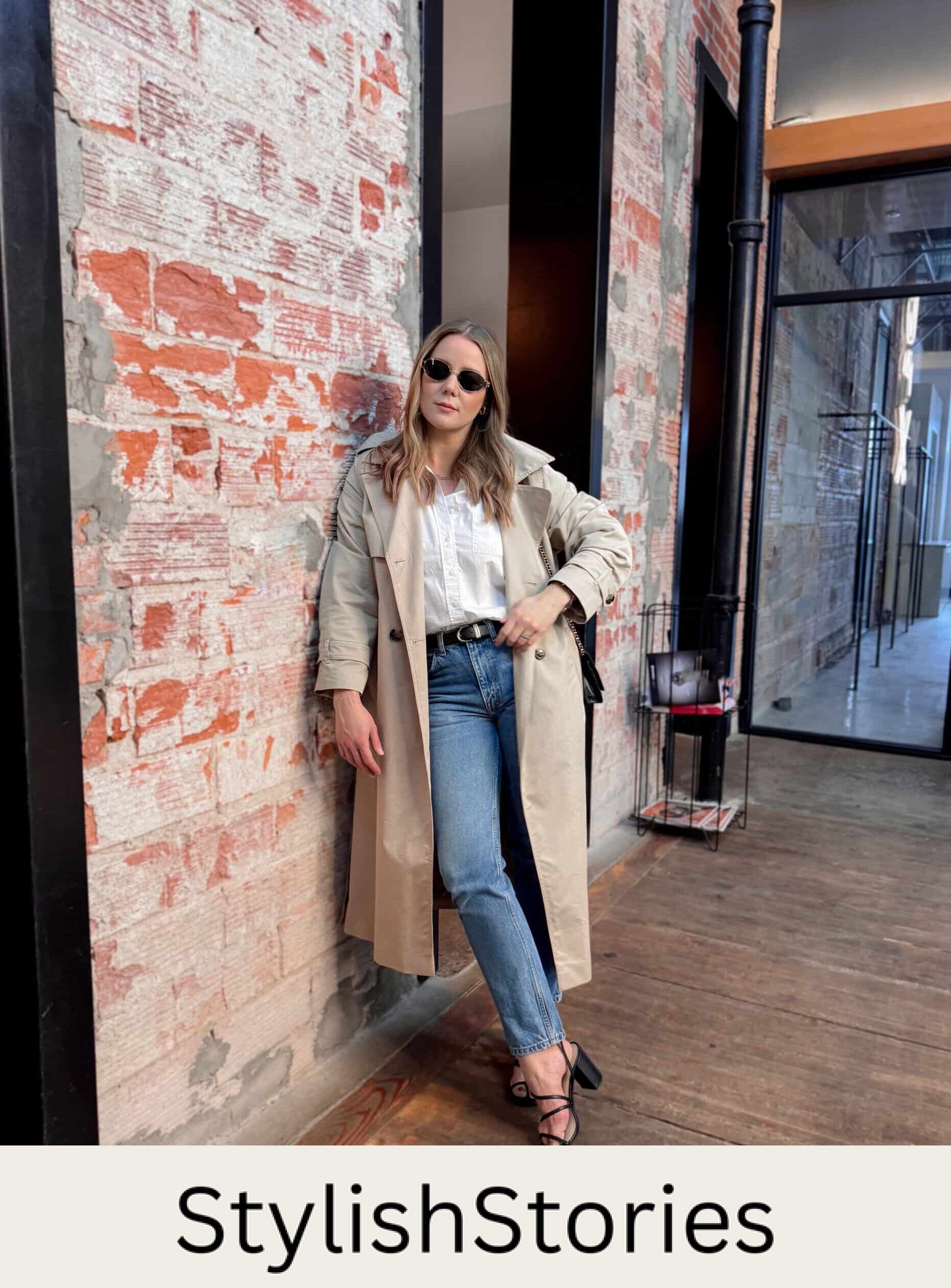 Christal wearing jeans, a white button down, a trench coat and black block heel sandals.