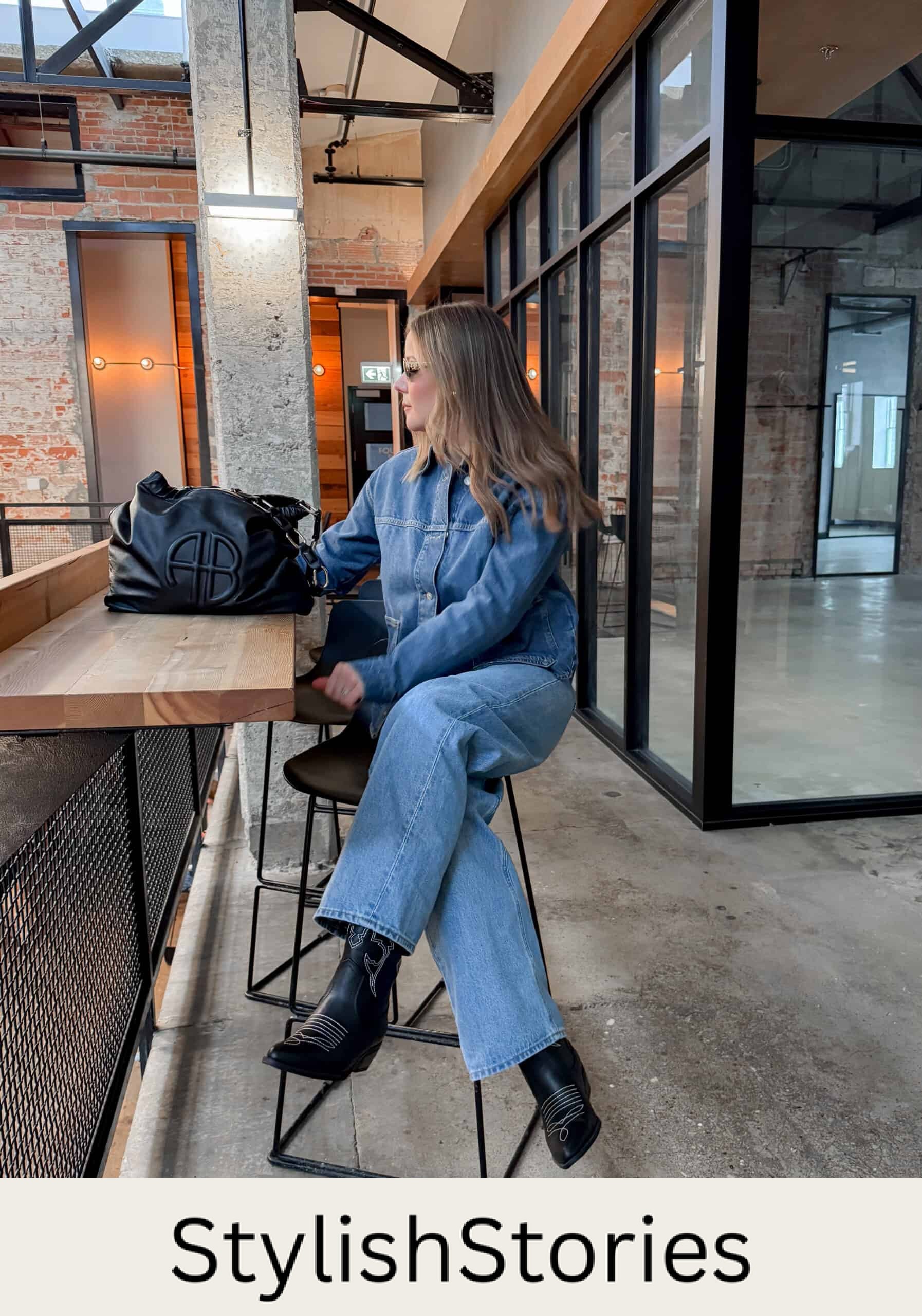 Christal wearing jeans, a denim button down and black western boots.