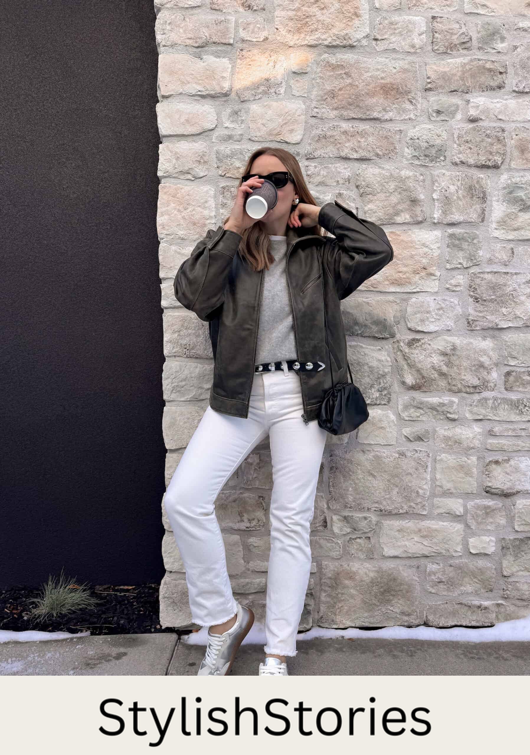 Christal wearing white jeans with a grey tee and grey jacket with white sneakers.