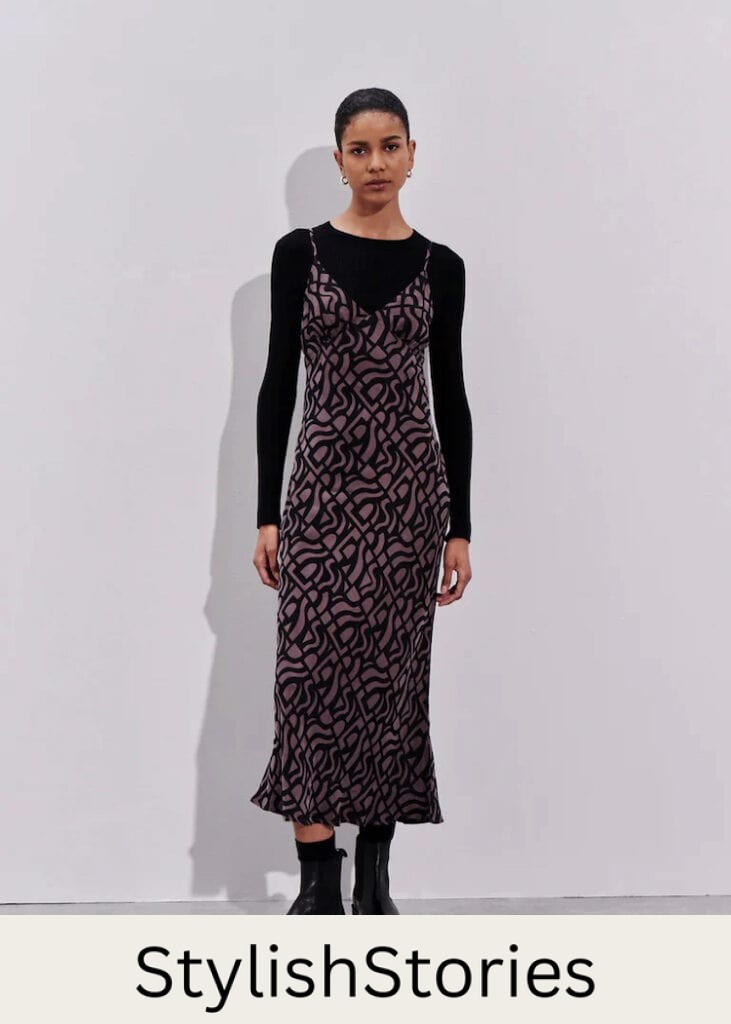 woman wearing a long sleeve top under a slip dress with lug boots in winter