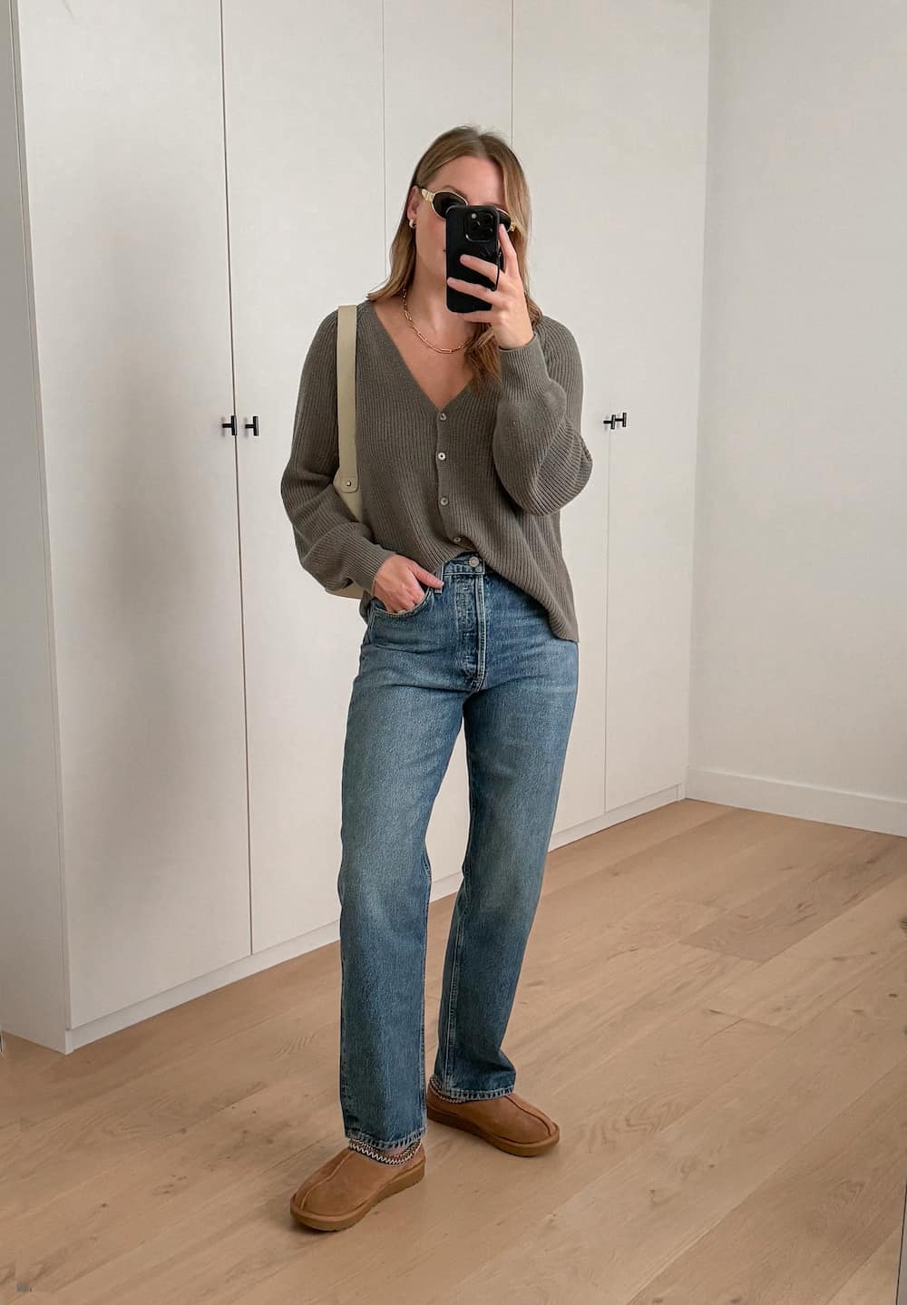 Christal wearing jeans, a grey cardigan and brown Ugg flats.