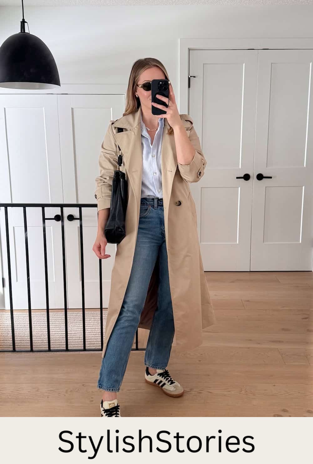 Christal wearing jeans, a white button down, jeans, sneakers and a trench coat.