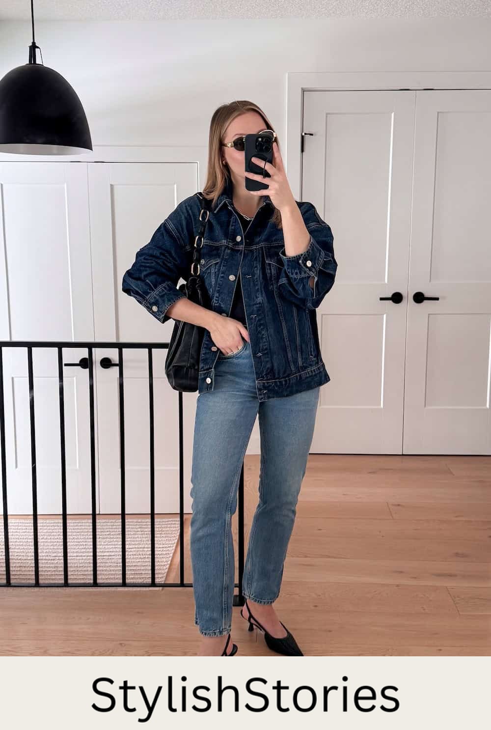 Christal wearing jeans, a black top, a denim jacket and black heels.