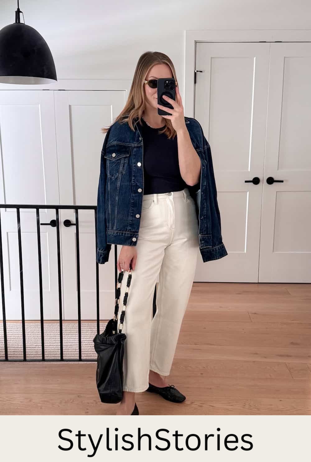 Christal wearing white jeans, a black tank top and a denim jacket with black flats.