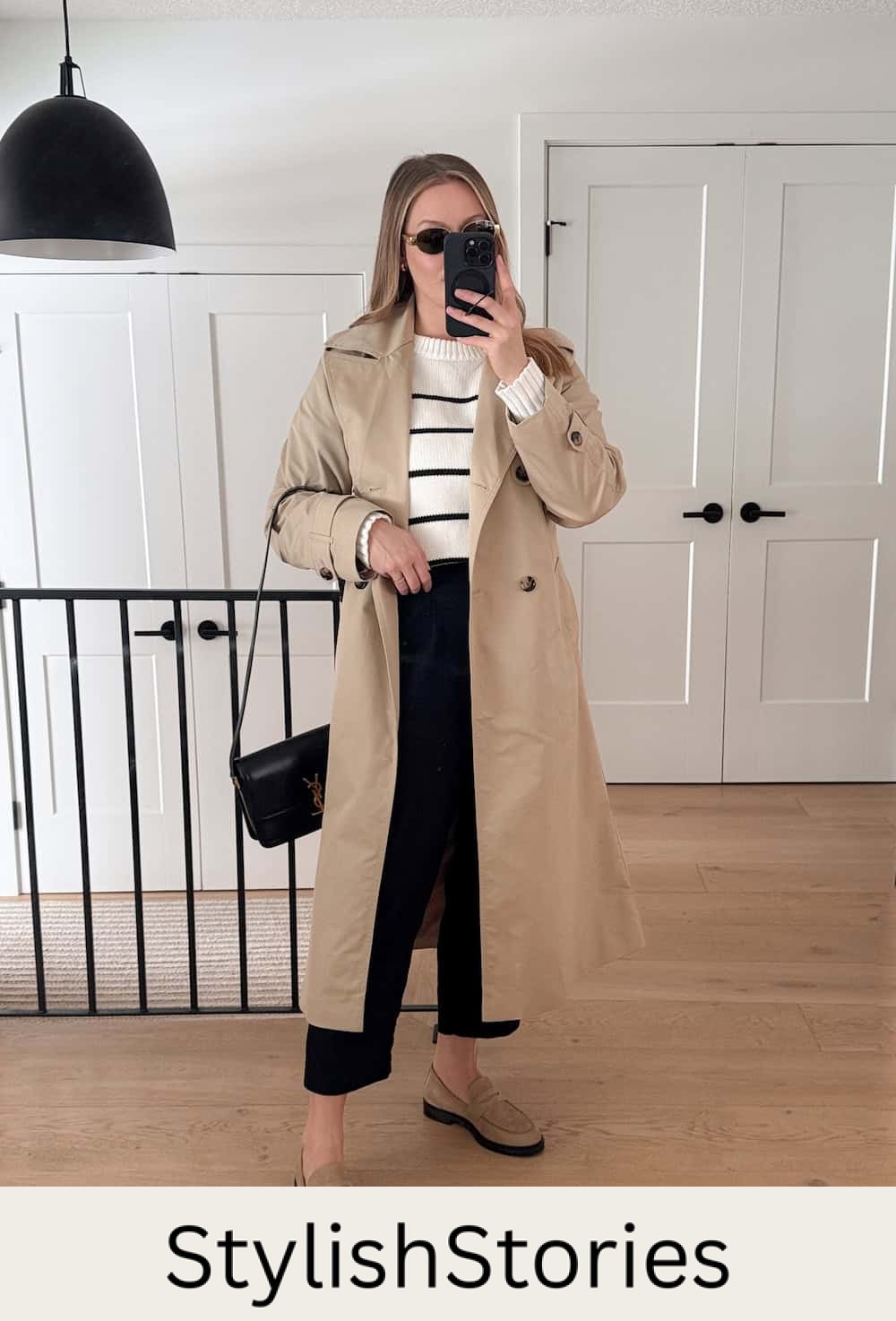 Christal wearing black pants, a white and black sweater and a trench coat.