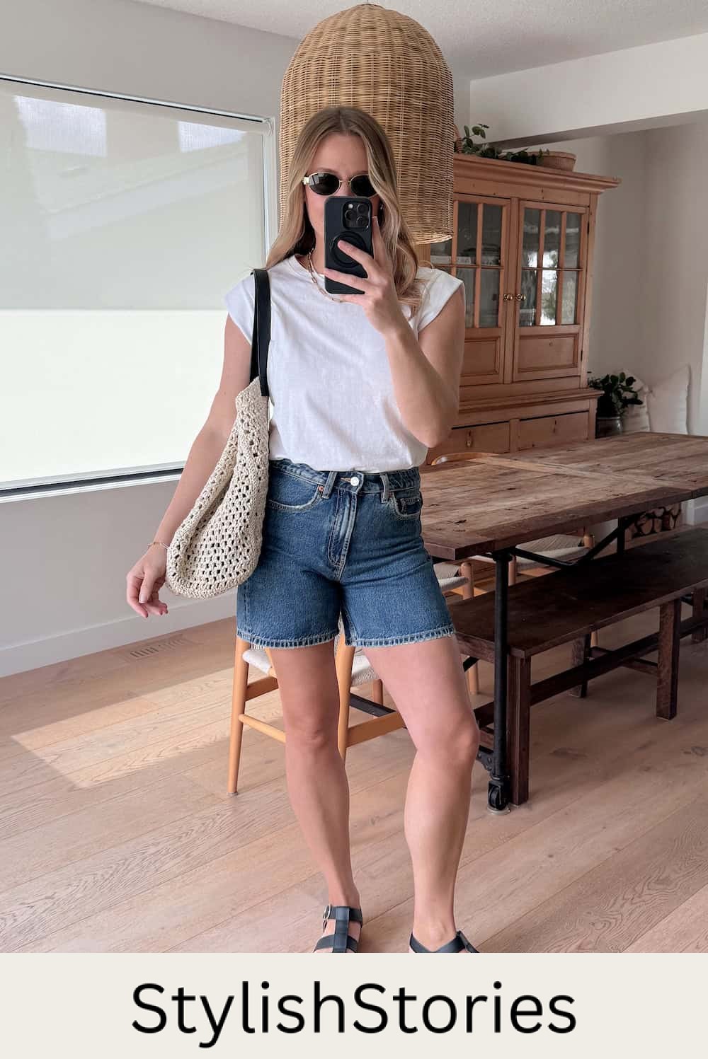 Christal wearing denim shorts with a white t-shirt and black sandals.