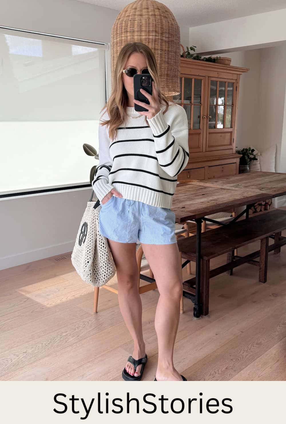 Christal wearing white and blue striped shorts with a white and black striped sweater.