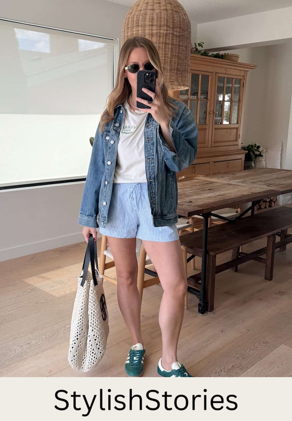 Christal wearing white and blue striped shorts, a t-shirt and a denim jacket with green sneakers.