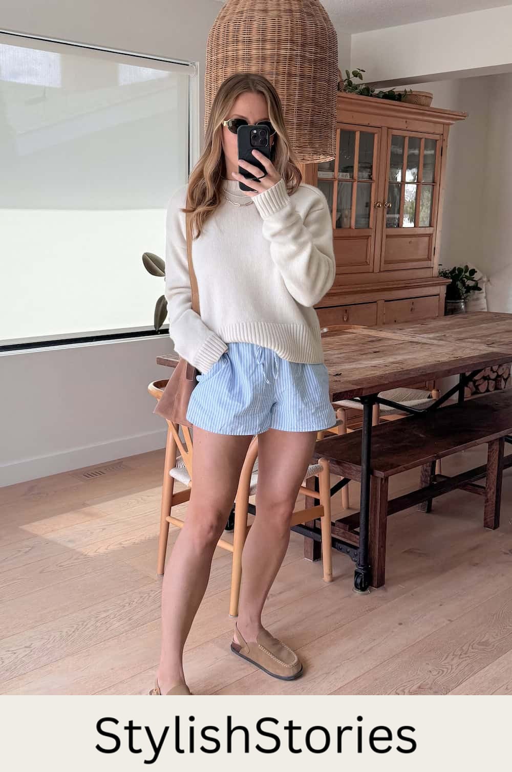Christal wearing white and blue striped boxer shorts with a cream sweater and cozy shoes.