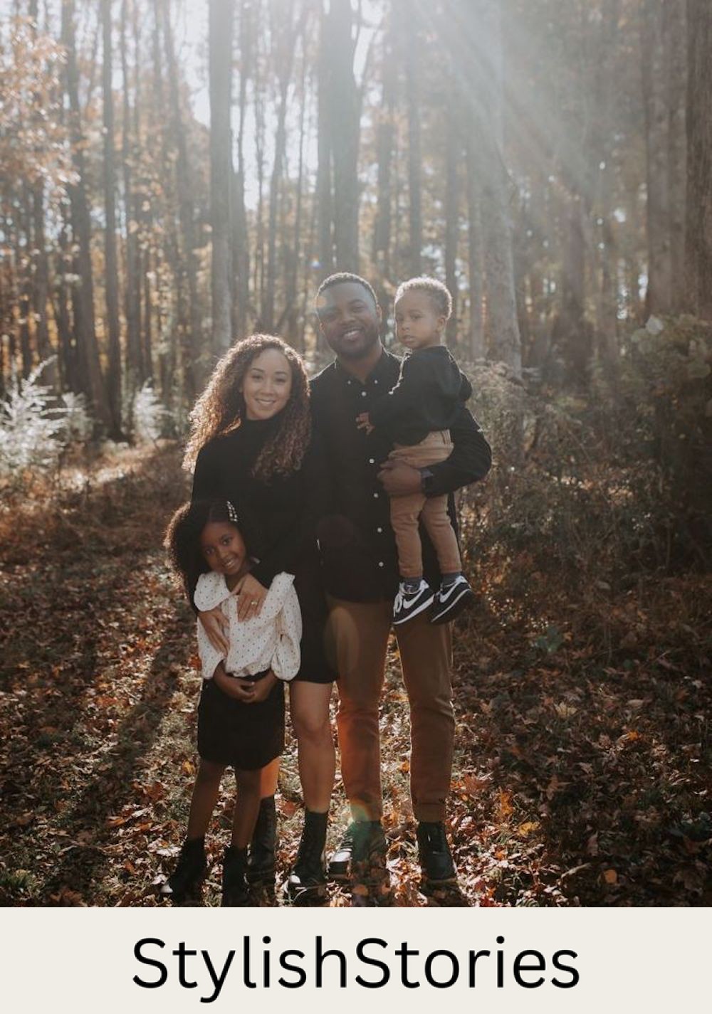 Image of a black family in the fall in the woods wearing black and camel color outfits 