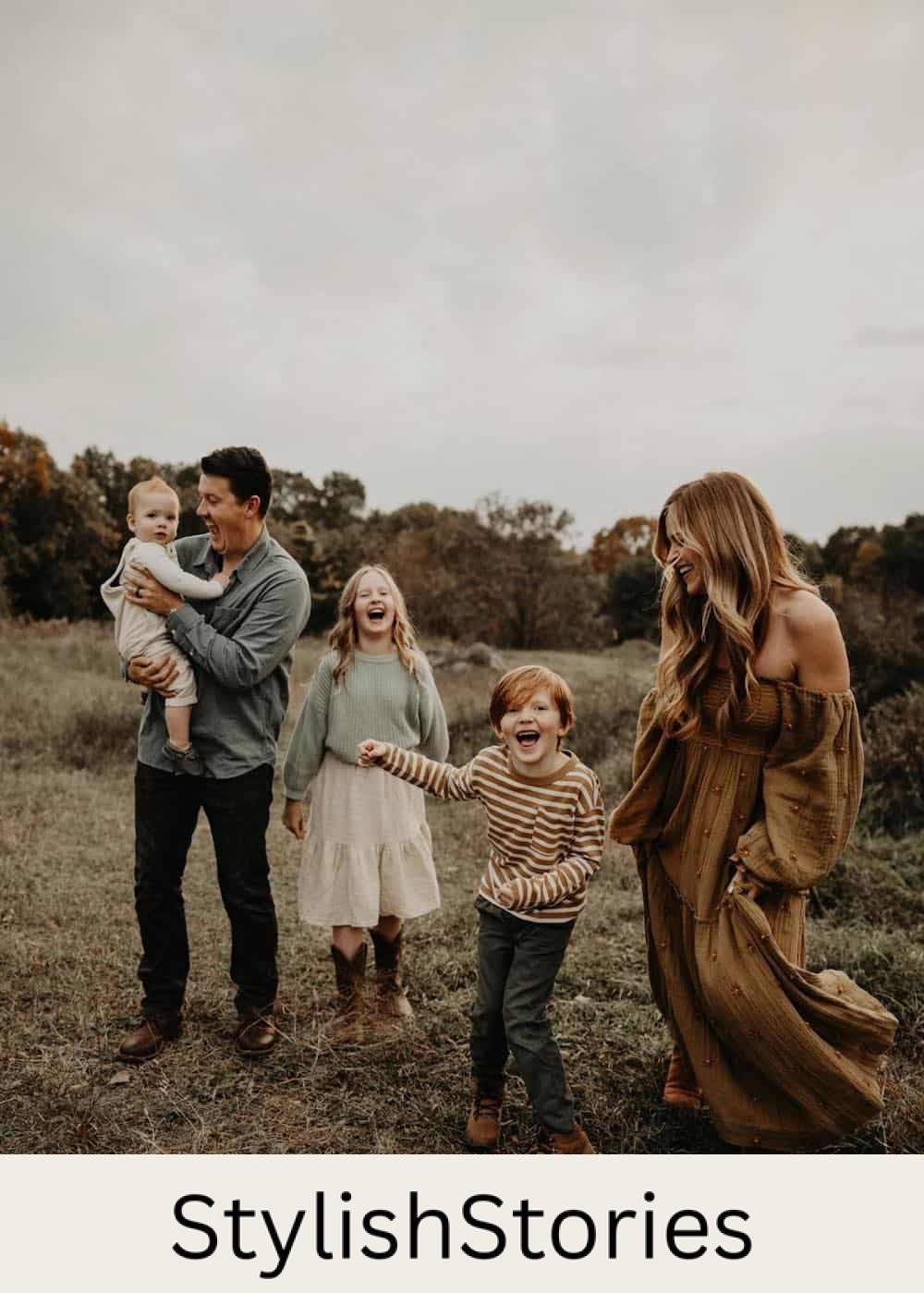 a fall family photo where the mom has a brown off the shoulder dress while the family wears cream and soft greens