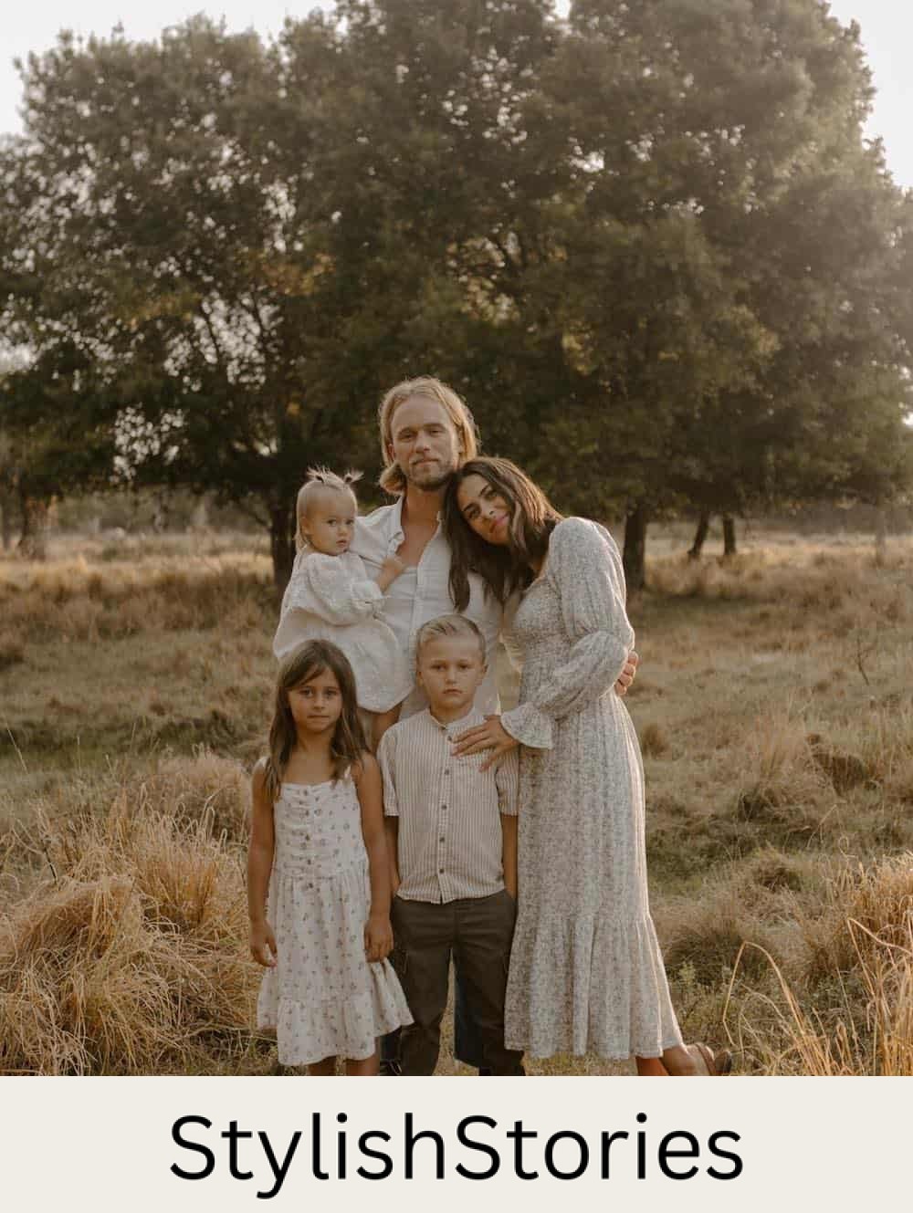 a family portrait featuring neutral outfits, floral prints, and dresses for the mom and girls