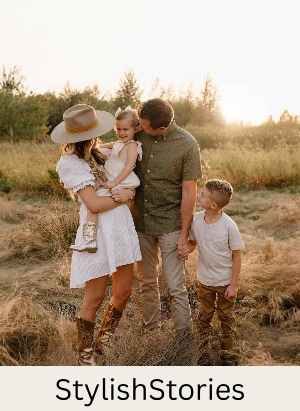 a fall family portrait where the mom is wearing a striped white mini dress, gold cowgirl boots, and a wide-brimmed hat while the rest of the family is dressed in neutrals with pops of warm fall colors