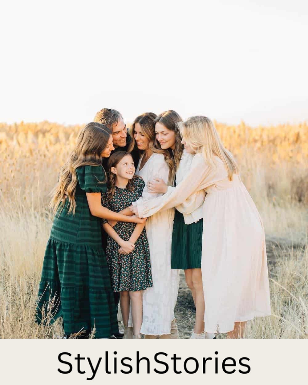 image of a family having an outdoor fall photoshoot wearing a mix of cream and forest green