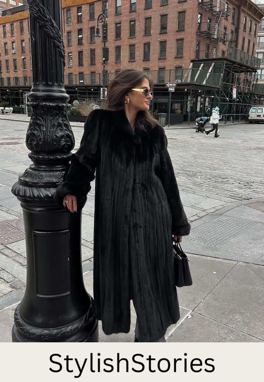Woman wearing jeans, booties and a full length faux fur coat.