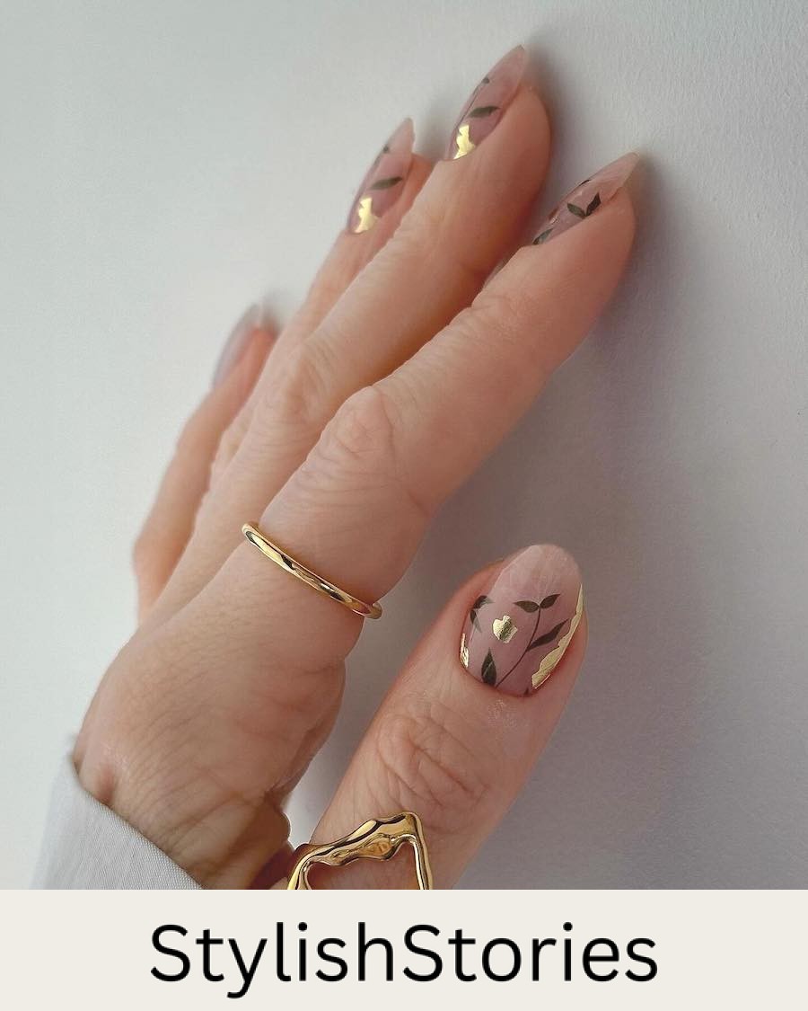 short glossy nude round nails with delicate green botanical art and gold foil accents