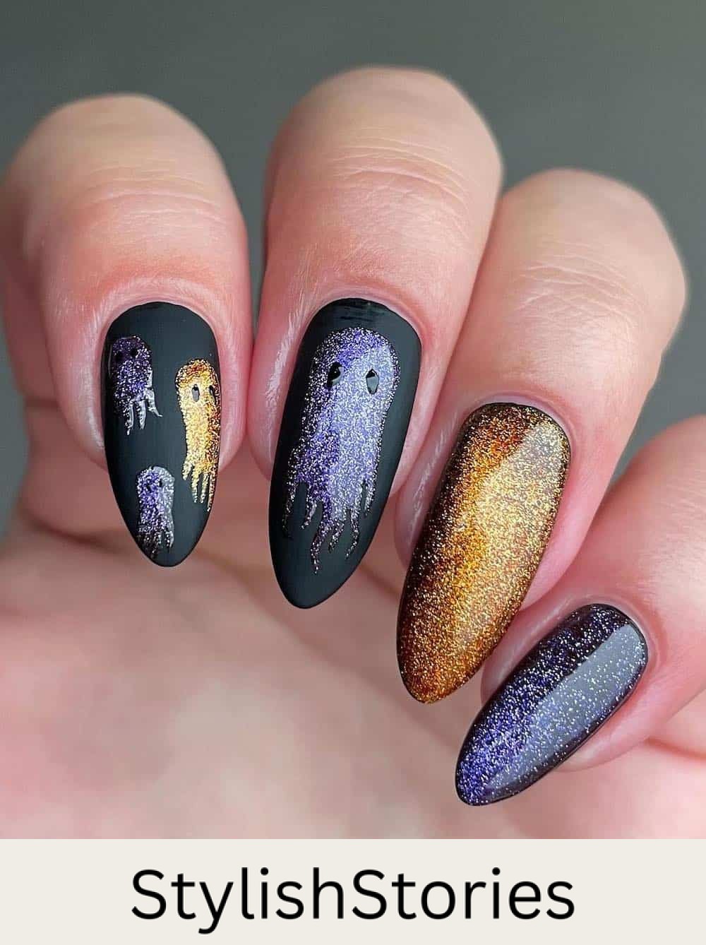 long glittering gold and purple polish on black almond nails featuring ghost nail art