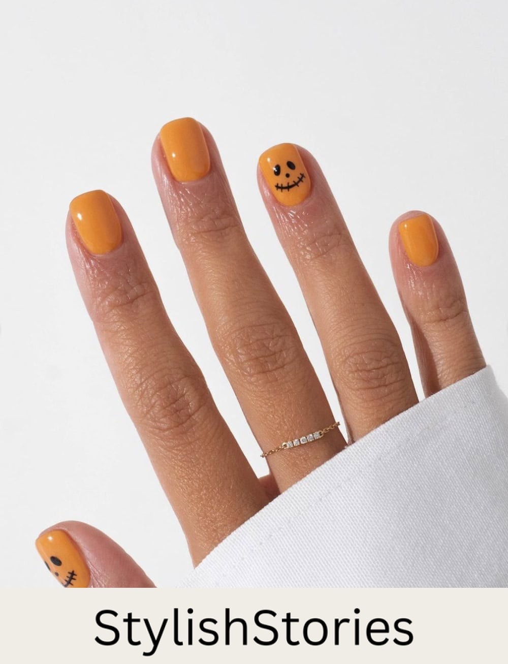 short orange nails with pumpkin face accent nails